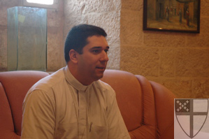 [Fr. Hosam Naoum, resident...]
