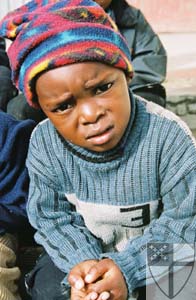 [A Namibian child looks on...]
